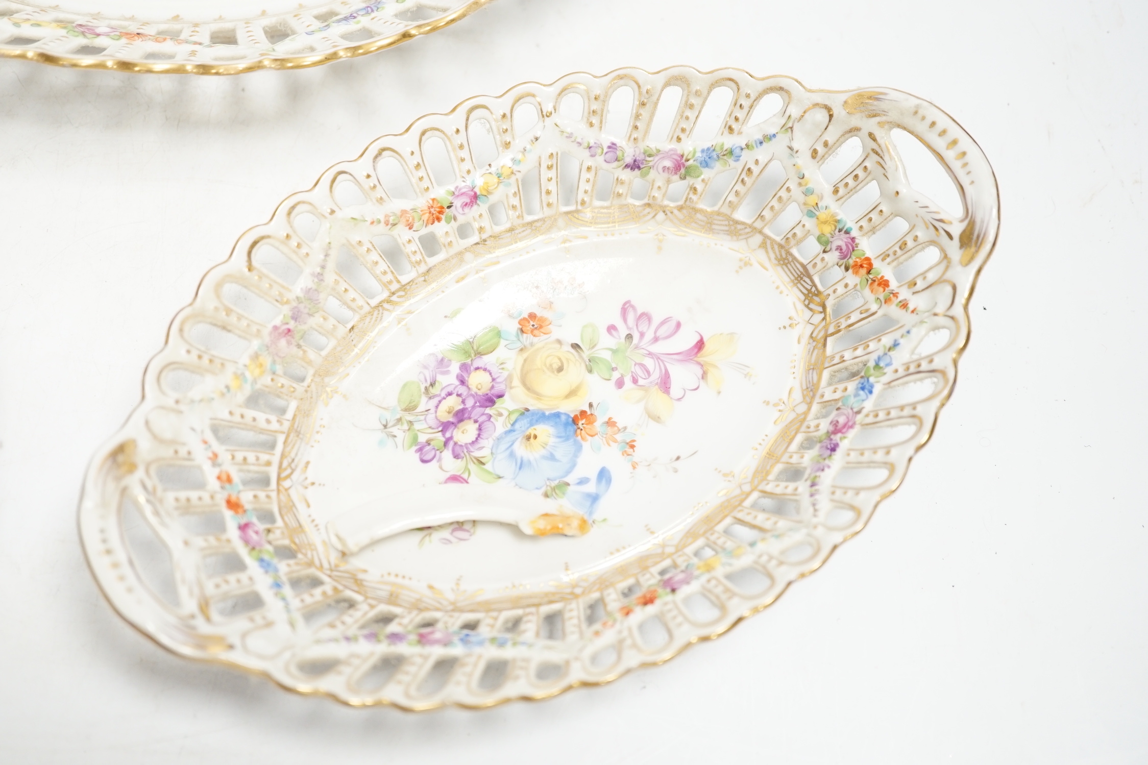 A trio of Dresden pierced floral painted porcelain oval baskets